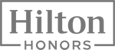 The image shows the Hilton Honors logo, featuring the words "Hilton Honors" in a bold font within a rectangular frame.