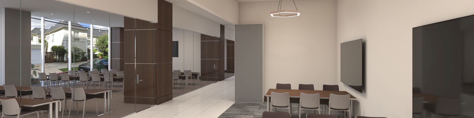 The image shows a modern conference room with tables, chairs, and screens, featuring overhead lighting and large windows on the side.